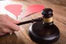 Divorce Judge With Broken Heart At Desk Hitting Gavel